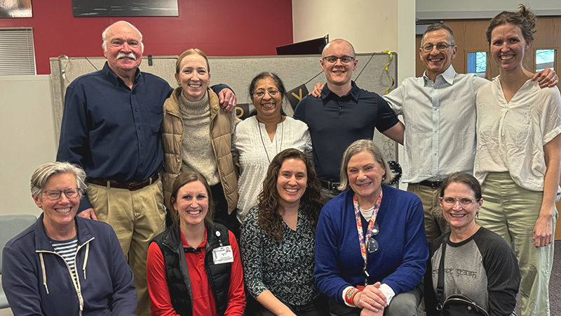 A group of people posing for the camera and smiling.
