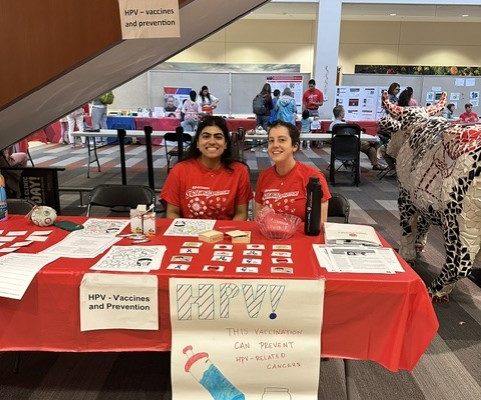 Drs. Avani Bellary and Julia Clemens sitting behind a table.