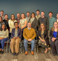 A group of people posing for a group photo.