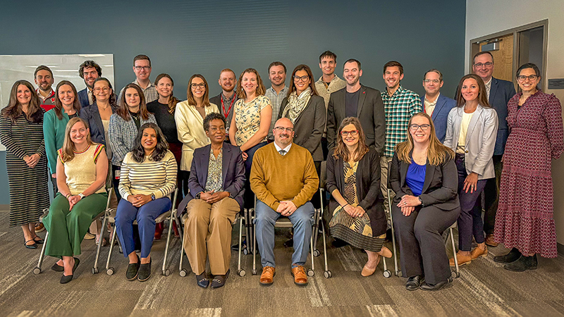 A group of people posing for a group photo.