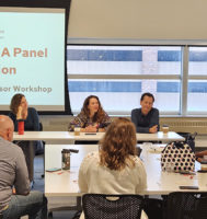 A group of people sitting around a conference table.