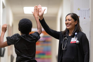 Dr. Mathus with a child in a clinic