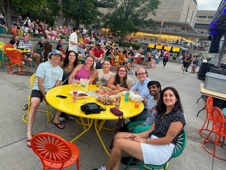 Residents sitting around a yellow terrace table at the Memorial Union Terrace