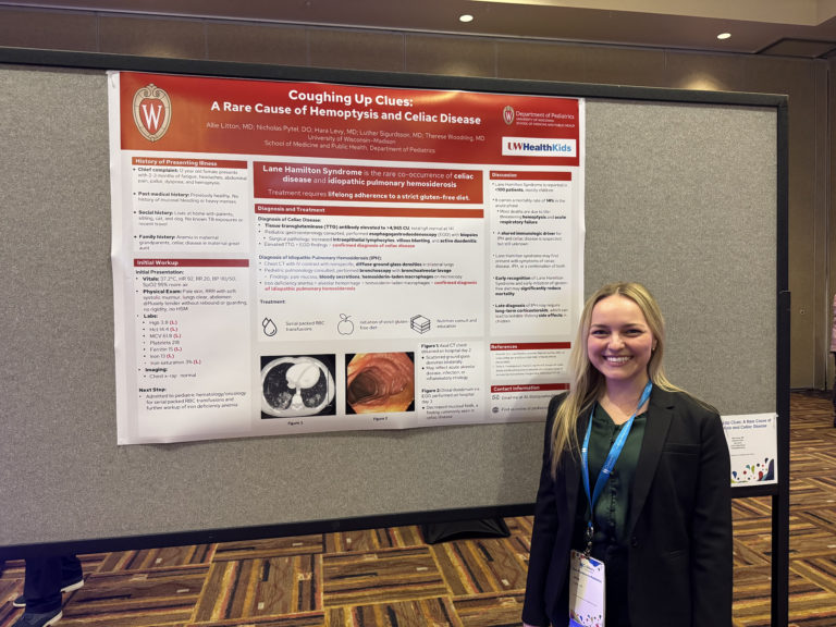 Dr. Allie Litton standing in front of her research poster.
