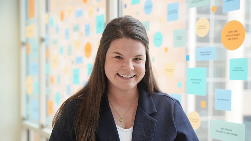 Dr. Brittany Lehrer standing in a glass hallway.